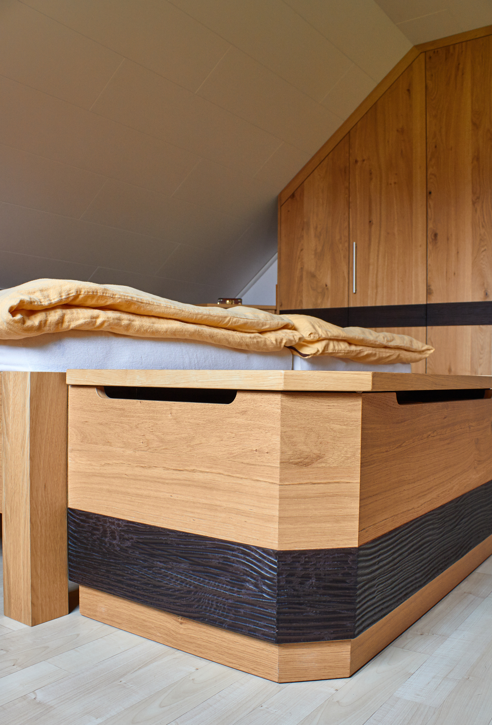 Schlafzimmer Eiche astig furniert, matt lackiert, Dekoelemente in Eiche gebeizt mit Wellenfräsung